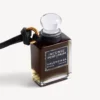 Miniatyrflaske med parfyme som anheng i svart